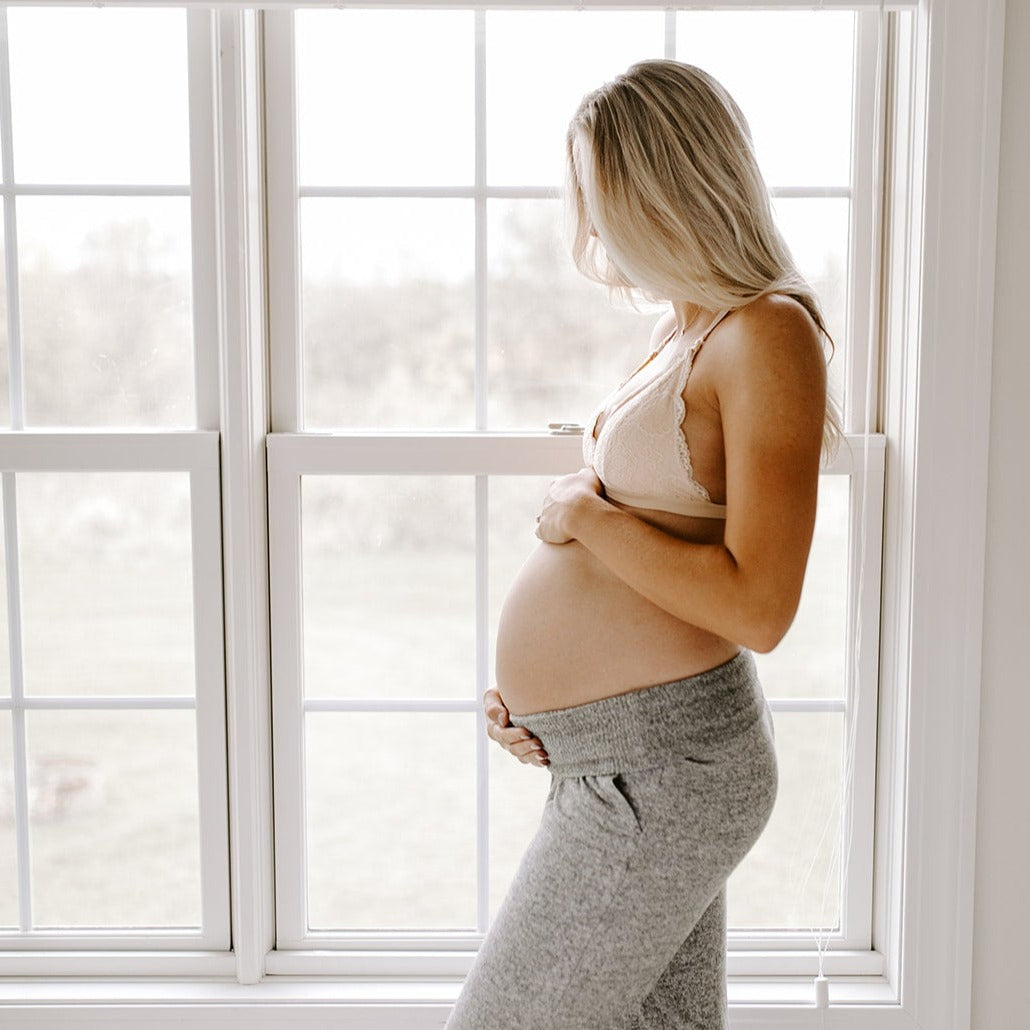 nude nursing bralette pregnant mom standing by window oh la lari